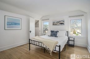 Grand Rapids apartment for rent - A bedroom with a bed, a nightstand, and a window.