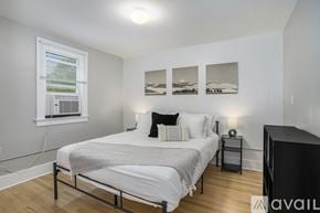 Grand Rapids apartment for rent - A bedroom with a bed, nightstand, and pictures on the wall.
