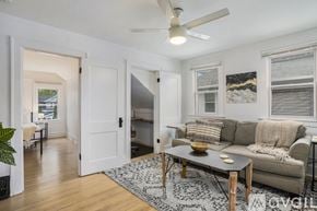 Grand Rapids apartment for rent - A living room with a couch, a coffee table, and a ceiling fan.