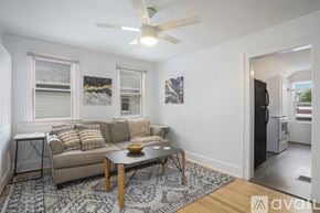 Grand Rapids apartment for rent - A living room with a couch, a coffee table, and a ceiling fan.