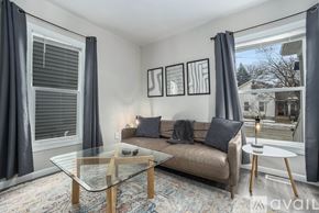 Grand Rapids apartment for rent - A living room with a couch, coffee table, and pictures on the wall.