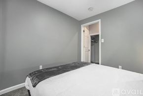 Grand Rapids apartment for rent - A bedroom with a bed and a doorway leading to another room.