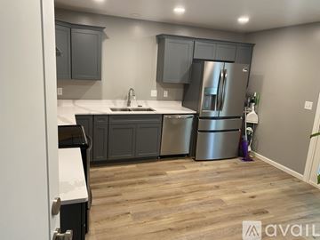 West Lafayette house for rent - A kitchen with a stainless steel refrigerator and wooden flooring.