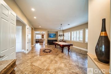 Palm Desert house for rent - A living room with a wooden table and a television.
