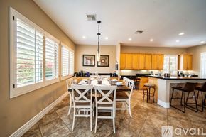 Palm Desert house for rent - A dining room with a table set for six people.