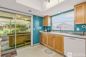 Ormond Beach house for rent - A kitchen with wooden cabinets and a white oven.
