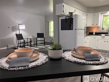 Saline apartment for rent - A modern kitchen with a dining table set for two.
