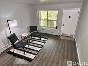 Saline apartment for rent - A room with a black chair and a black and white striped rug.