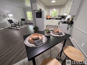 Saline apartment for rent - A modern kitchen with a dining table set for two.