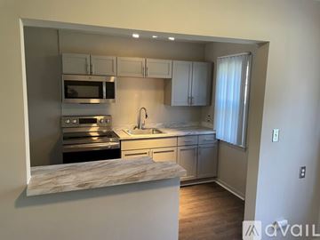 Detroit apartment for rent - A kitchen with a marble countertop and stainless steel appliances.
