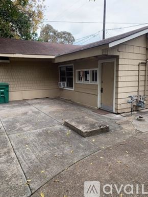 Houston apartment for rent - A small house with a green container in front.