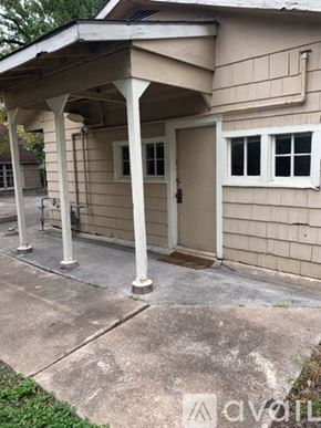 Houston apartment for rent - A beige house with a white door and windows.