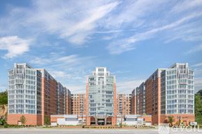 North Bergen condo for rent - A large building complex with multiple glass-fronted buildings.