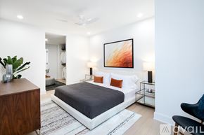 North Bergen condo for rent - A bedroom with a bed, a chair, and a painting on the wall.