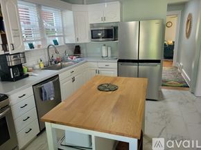 St. Joseph house for rent - A kitchen with a wooden table in the middle.