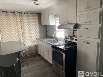 Lancaster apartment for rent - A kitchen with a black stove top oven and white cabinets.