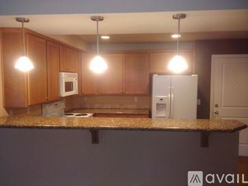 Seattle apartment for rent - A kitchen with brown cabinets and granite countertops.