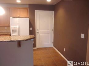 Seattle apartment for rent - A kitchen with brown cabinets and a white refrigerator.