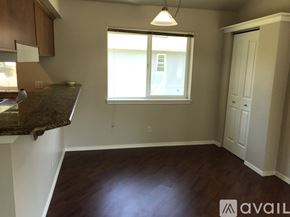 Seattle apartment for rent - A room with a brown countertop and a window with white blinds.