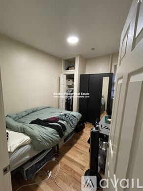 Boston apartment for rent - A bedroom with a bed, a wardrobe, and a desk.