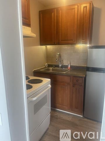 Delaware apartment for rent - A kitchen with wooden cabinets and a white refrigerator.