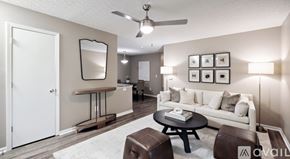 Blacklick apartment for rent - A living room with a white couch, a coffee table, and a mirror on the wall.