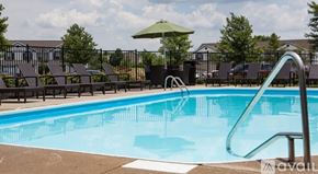 Blacklick apartment for rent - A pool with a slide and chairs around it.
