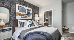 Powell apartment for rent - A bedroom with a large bed, a nightstand with a lamp, and a painting on the wall.