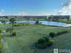 Fort Myers condo for rent - A grassy field with a body of water and a bridge in the distance.