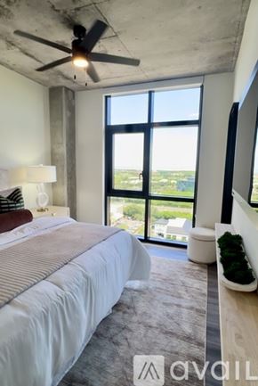 St. Petersburg apartment for rent - A bedroom with a large bed and a ceiling fan.