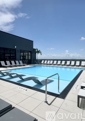St. Petersburg apartment for rent - A swimming pool with a metal ladder and a building in the background.