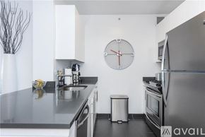 Queens house for rent - A modern kitchen with a clock on the wall.