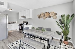 Indio apartment for rent - A modern kitchen with a dining table and chairs.