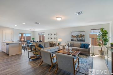 Bullhead City apartment for rent - A living room with a grey couch and a wooden coffee table.