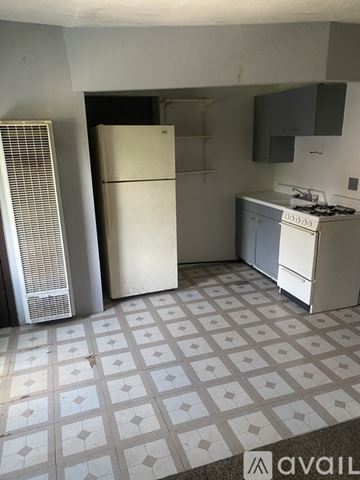 Belvidere apartment for rent - A kitchen with a white fridge, white stove, and a white tile floor.