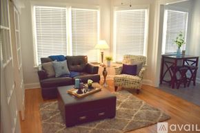 Tampa apartment for rent - A living room with a brown couch, a chair, and a coffee table.