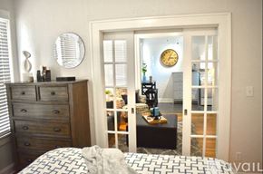 Tampa apartment for rent - A bedroom with a bed, dresser, and mirror.