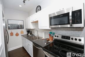 Tampa apartment for rent - A kitchen with a stove, microwave, and oven.