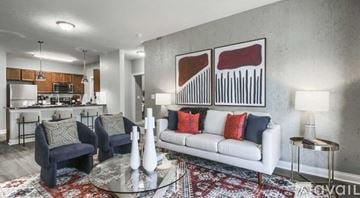 Powell apartment for rent - A living room with a white couch and a rug.