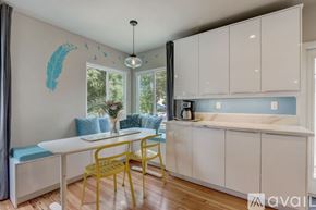 San Diego house for rent - A dining area with a white table and yellow chairs.