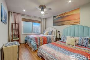 San Diego house for rent - A bedroom with two beds and a ceiling fan.