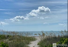 Cocoa Beach condo for rent - A beach scene with a path leading to the water.