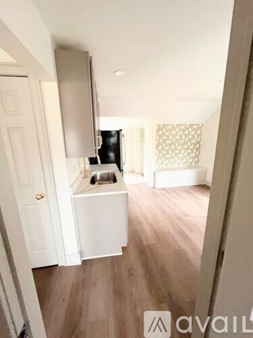 Saline house for rent - A small kitchen with a sink and a refrigerator.