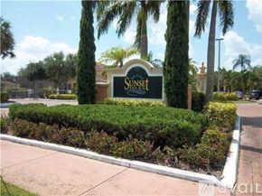 Royal Palm Beach condo for rent - A sign that says "Sunset" is in front of some trees.