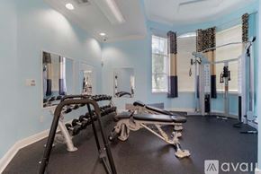 Royal Palm Beach condo for rent - A gym with a mirrored wall and a row of dumbbells.