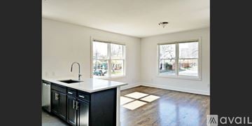 Dallas apartment for rent - A kitchen with black cabinets and a white countertop.