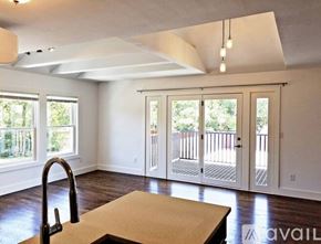 Dallas apartment for rent - A kitchen with a sink and a table in the middle of the room.