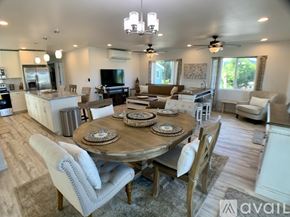 Kailua house for rent - A well-lit, spacious kitchen and dining area with a wooden table set for a meal.
