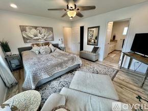 Kailua house for rent - A bedroom with a large bed and a ceiling fan.