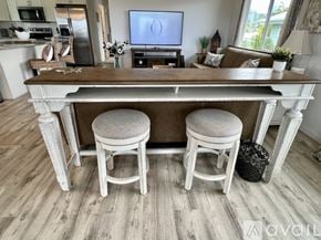 Kailua house for rent - A kitchen with a wooden island and two stools.